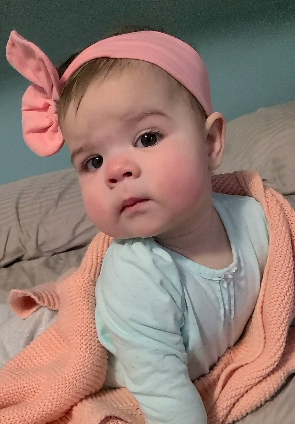 Emma Fae is registered to the contest to win money with this photo: baby, baby_toddler_clothing, bonnet, cheek, child, comfort, costume_accessory, ear, eye, finger, gesture, hair_accessory, headband, headgear, headpiece, lip, person, pink, skin, thumb