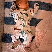 David joined the competition — help win amazing prizes! baby, sleeping, onesie, dinosaur_print, blanket, striped, soft_texture, infant, cozy, child, cute, sleep, footed_pajamas, nursery, rest, peaceful, indoors, portrait, comfort, young
