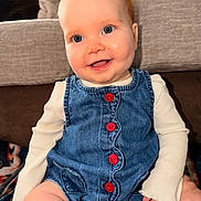 Emery joined the competition — help win amazing prizes! baby, blue_eyes, child, clothing, couch, cute, denim_dress, furniture, happy, indoor, infant, long_sleeve_shirt, person, pillow, ponytail, portrait, red_buttons, sitting, skin, smiling