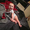 Jaeger is registered to the contest to win money with this photo: baby, bed, blanket, smile, infant, child, pillow, home, indoor, person, cute, happy, clothing, toddler, furniture, room, sleeping_area, comfort, rest, portrait