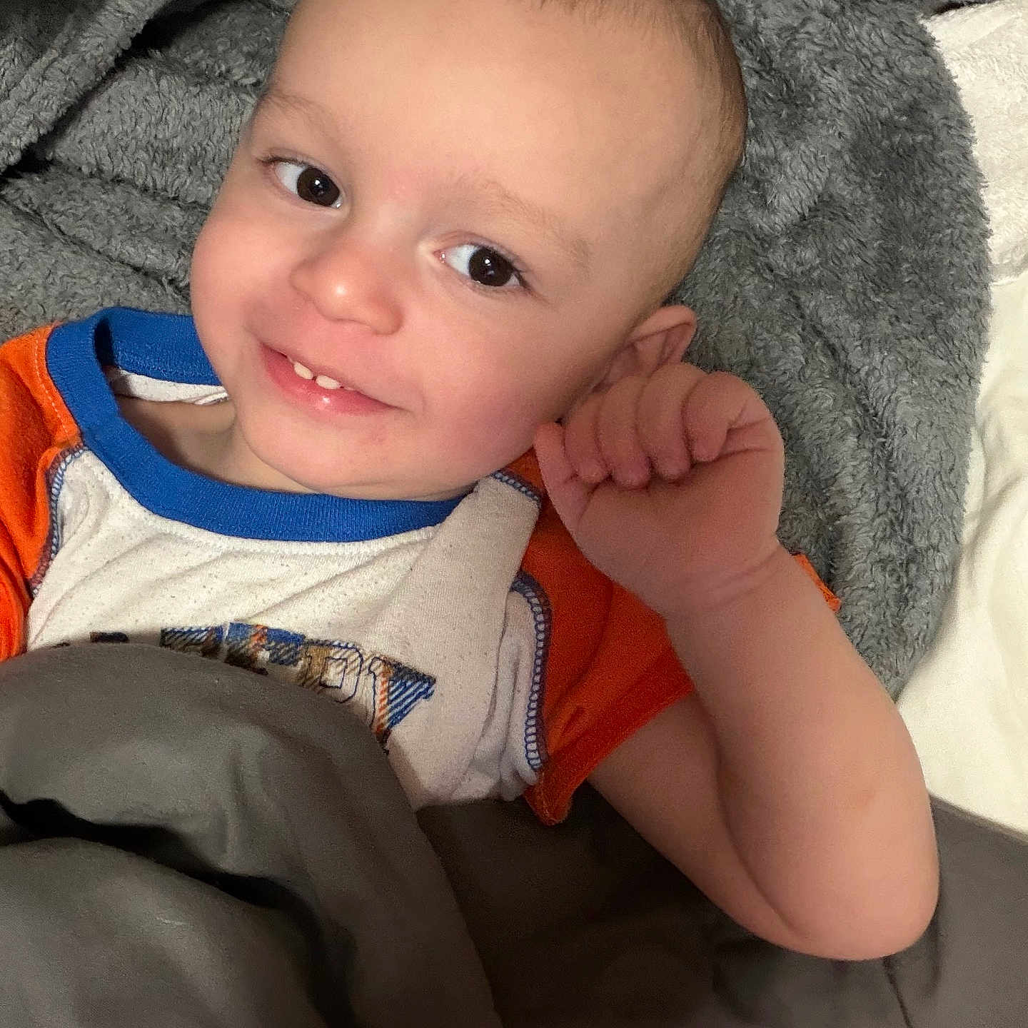 Jaeger joined the competition — help win amazing prizes! child, toddler, smile, face, blanket, bed, clothing, cute, happy, indoors, person, portrait, resting, young_child, head, eyes, hand, skin, cozy, warm