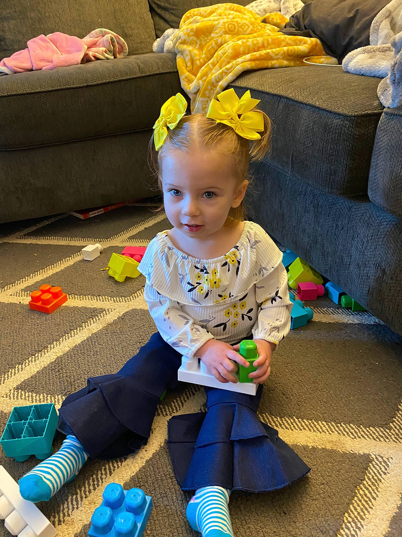 Adalyn joined the competition — help win amazing prizes! baby, baby_products, baby_toddler_clothing, baby_toys, child, comfort, couch, electric_blue, fashion_accessory, flooring, fun, happy, pattern, person, play, sitting, smile, sock, textile, toddler