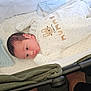 Zayne joined the competition — help win amazing prizes! baby, newborn, bassinet, onesie, blanket, infant, sleepwear, face, person, lying_down, soft_fabric, knit_blanket, carrying_handle, footwear_absent, indoors, floor, curious_expression, cute, white_clothing, resting