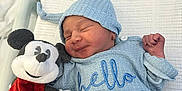 Zayne joined the competition — help win amazing prizes! newborn, baby, sleeping, blue_clothing, knit_hat, mickey_mouse, plush_toy, blanket, hospital_bassinet, cute, infant, soft_texture, peaceful, child, toy, bed, cozy, smiling_face, resting, indoors