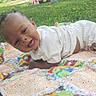 baby, blanket, child, clothing, cute, grass, happy, infant, lying_down, nature, outdoor, playing, plush_toy, shorts, smiling, socks, sunlight, toddler, toy, white_shirt
