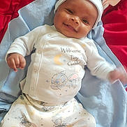 Clark Harris Jr joined the competition — help win amazing prizes! baby, smiling, pajamas, hat, ears, blanket, red_background, blue_blanket, infant, cute, clothing, lying_down, happy, soft, child, indoors, person, portrait, comfort, sleepwear