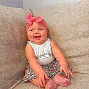 Jovee joined the competition — help win amazing prizes! baby, child, smiling, headband, bow, couch, sitting, happy, cute, infant, clothing, pink, skin, feet, arms, face, portrait, indoors, person, toddler