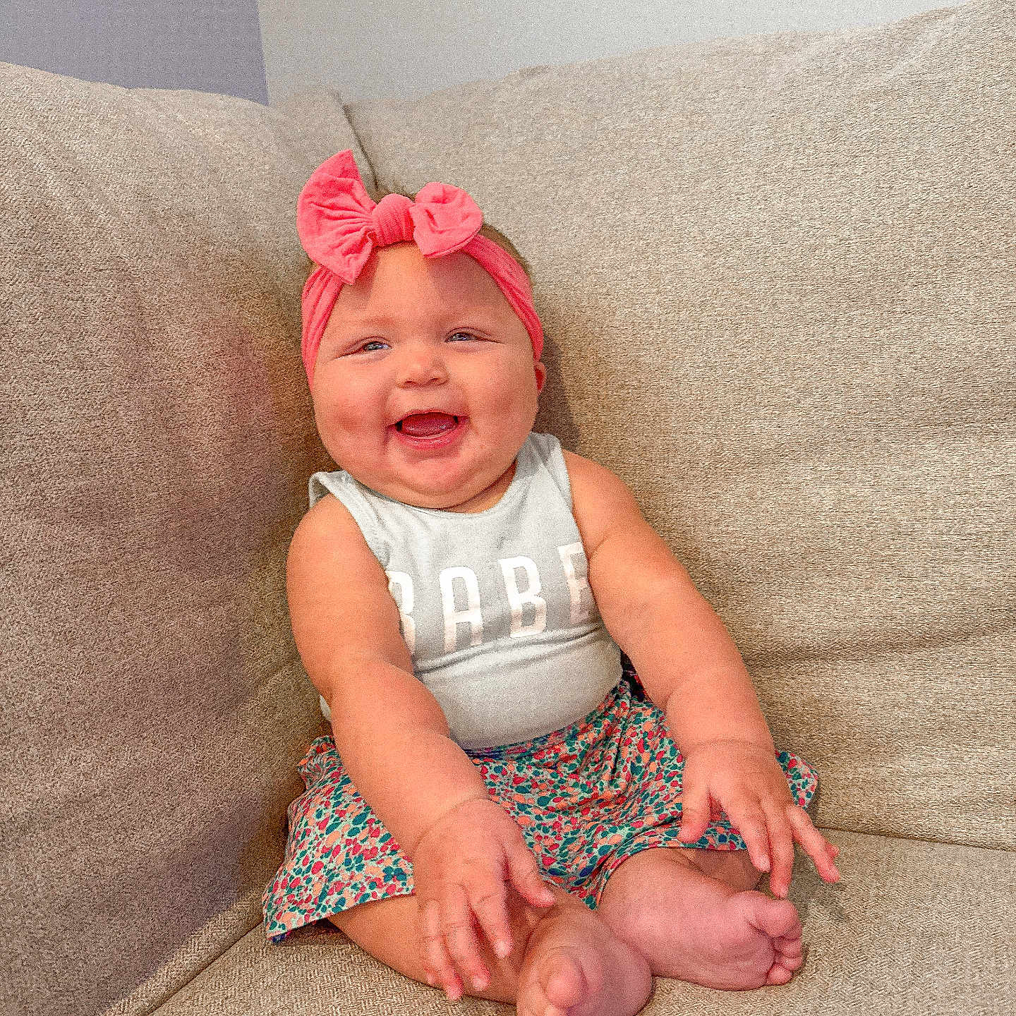 Jovee joined the competition — help win amazing prizes! arms, baby, bow, child, clothing, couch, cute, face, feet, happy, headband, indoors, infant, person, pink, portrait, sitting, skin, smiling, toddler