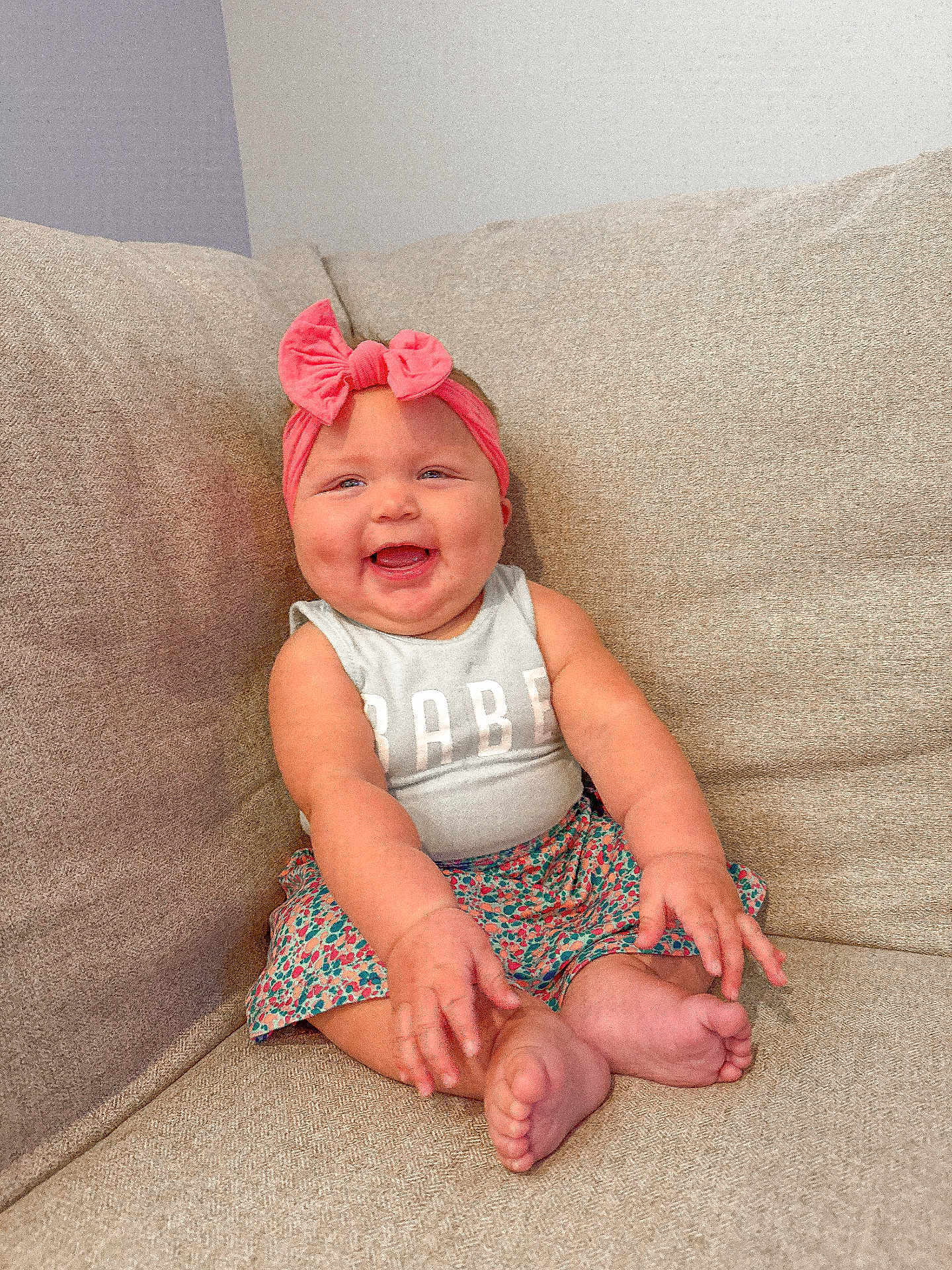 Jovee joined the competition — help win amazing prizes! baby, child, smiling, headband, bow, couch, sitting, happy, cute, infant, clothing, pink, skin, feet, arms, face, portrait, indoors, person, toddler