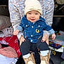 baby, infant, smiling, beanie, denim_jacket, cowboy_boots, socks, adult_hands, sweater, seated, toys, blanket, play_area, portrait, happy, cute, clothing, indoor, family, nursery