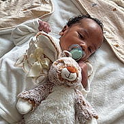 Djaymaël participe au concours pour gagner de l'argent avec cette photo : baby, blanket, child, comfort, cozy, cute, face, hand, head, indoors, infant, lying_down, pacifier, person, plush_toy, resting, sleepwear, soft_texture, stuffed_animal, young