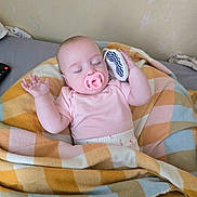Ruairi-Rae is registered to the contest to win money with this photo: baby, pacifier, blanket, sleeping, toy, infant, child, bed, pastel_colors, cozy, rest, comfort, clothing, peaceful, indoor, person, cute, soft, hands, face