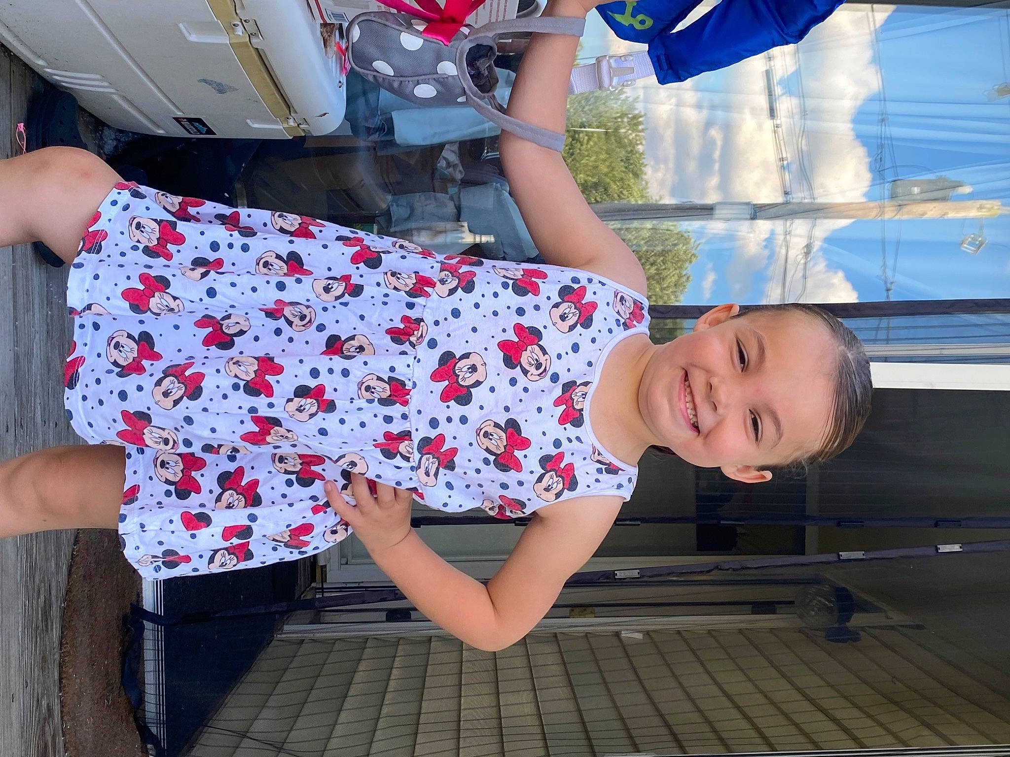 Aubrianna is registered to the contest to win money with this photo: arm, blue, child, day_dress, electric_blue, eyewear, fashion_accessory, fun, happy, human_leg, joint, joy, leisure, pattern, person, sandal, sitting, standing, thigh, toddler