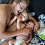 Apollo joined the competition — help win amazing prizes! man, child, baby, couch, blanket, diaper, bottle, video_game_controller, pillow, shirtless, family, smile, face, glasses, beard, indoor, relaxing, playful, holding, home