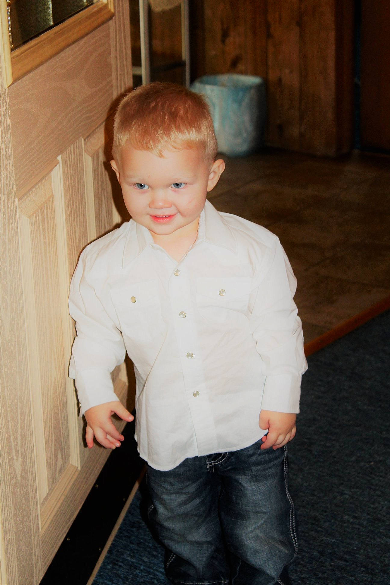 Kenton is registered to the contest to win money with this photo: blond, cheek, child, face, family, joy, person, smile, standing, toddler, vacation, wood