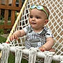 baby, child, sunglasses, hammock, outdoor, greenery, wooden_fence, striped_clothing, cute, smiling, infant, seat, rope, summer, sun_protection, happy, portrait, casual, playful, relaxed