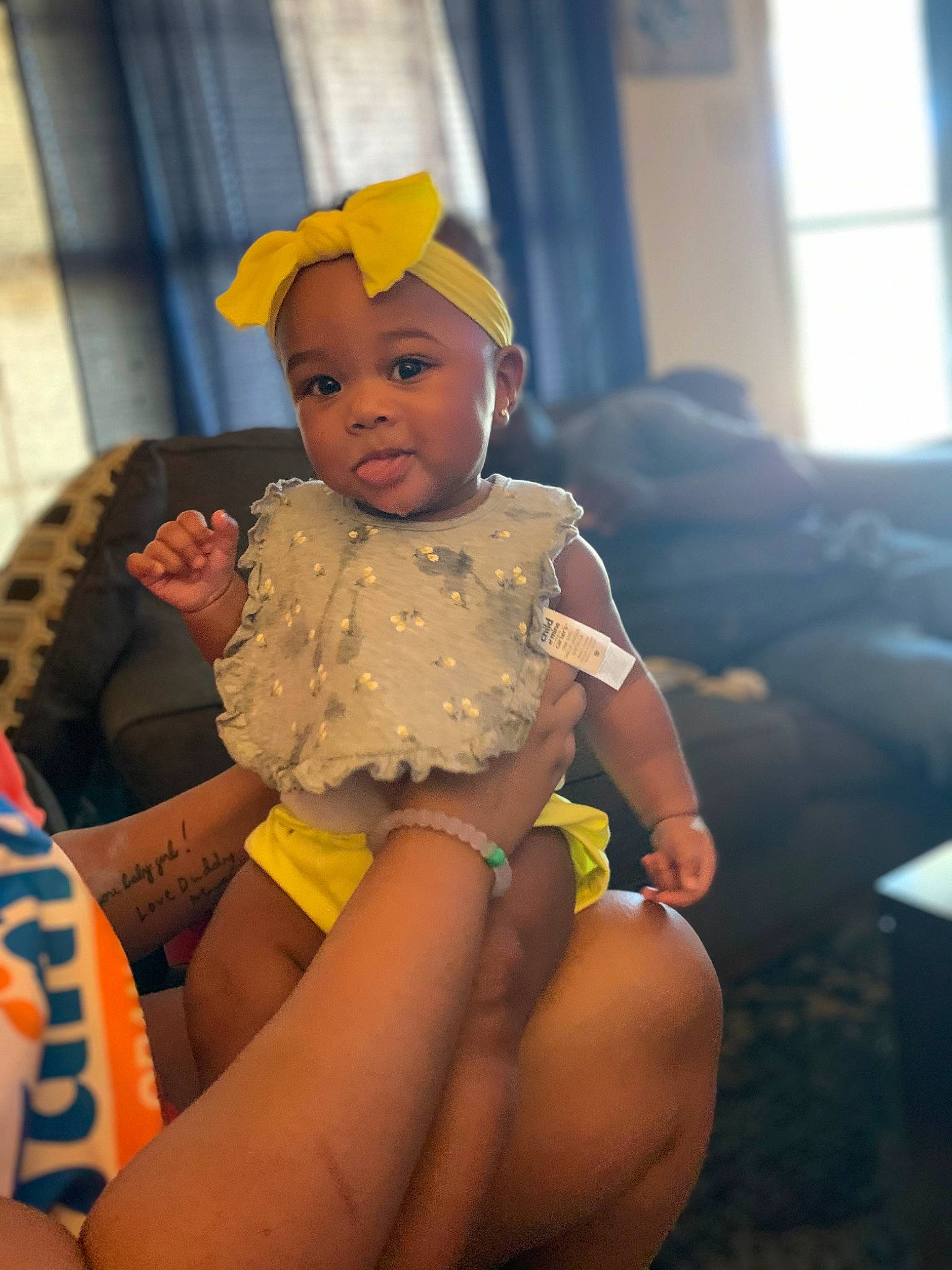 Makenzy is registered to the contest to win money with this photo: baby, baby_toddler_clothing, comfort, couch, eye, face, finger, fun, happy, hat, headgear, human_leg, lap, leisure, mouth, person, skin, thigh, toddler, trunk