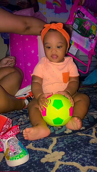 Makenzy joined the competition — help win amazing prizes! baby, ball, beauty, child, football, fun, happy, human_leg, leisure, pattern, person, pink, play, recreation, sitting, soccer_ball, sports_equipment, thigh, toddler, toy