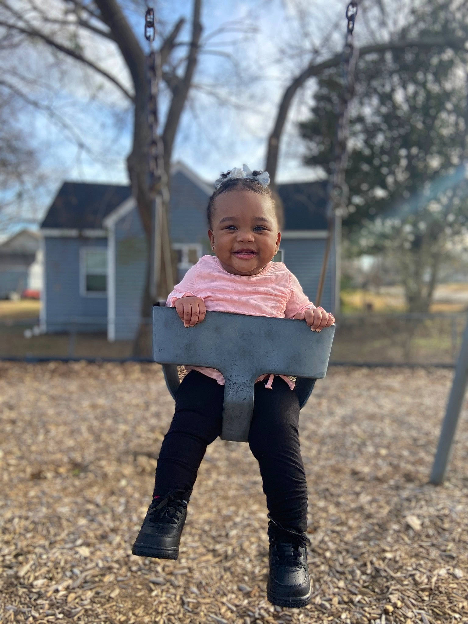 Makenzy is registered to the contest to win money with this photo: baby, baby_toddler_clothing, child, face, flash_photography, gesture, grass, happy, joy, leisure, people_in_nature, person, plant, recreation, sitting, sky, sleeve, soil, swing, t_shirt