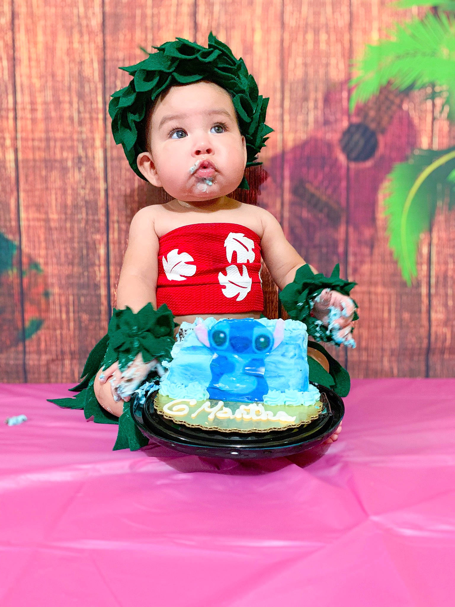 Anahi is registered to the contest to win money with this photo: baby, birthday, black_hair, child, costume, green, hair_accessory, happy, headwear, party, person, smile, surprise, toddler