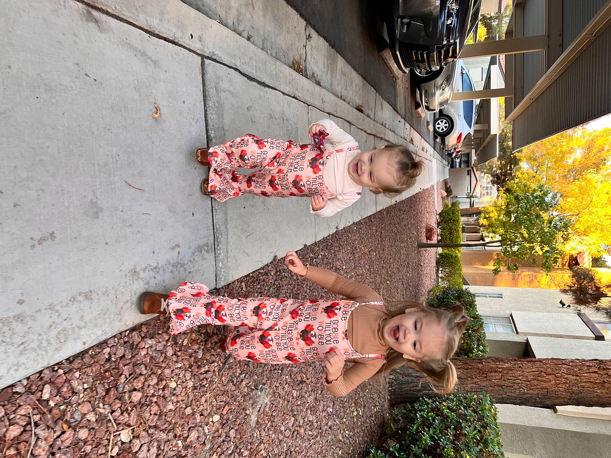 Emory is registered to the contest to win money with this photo: city, cobblestone, concrete, grass, human_leg, joy, leisure, pattern, pedestrian, people_in_nature, person, plant, road, road_surface, shadow, sidewalk, sitting, street, temple, tints_and_shades