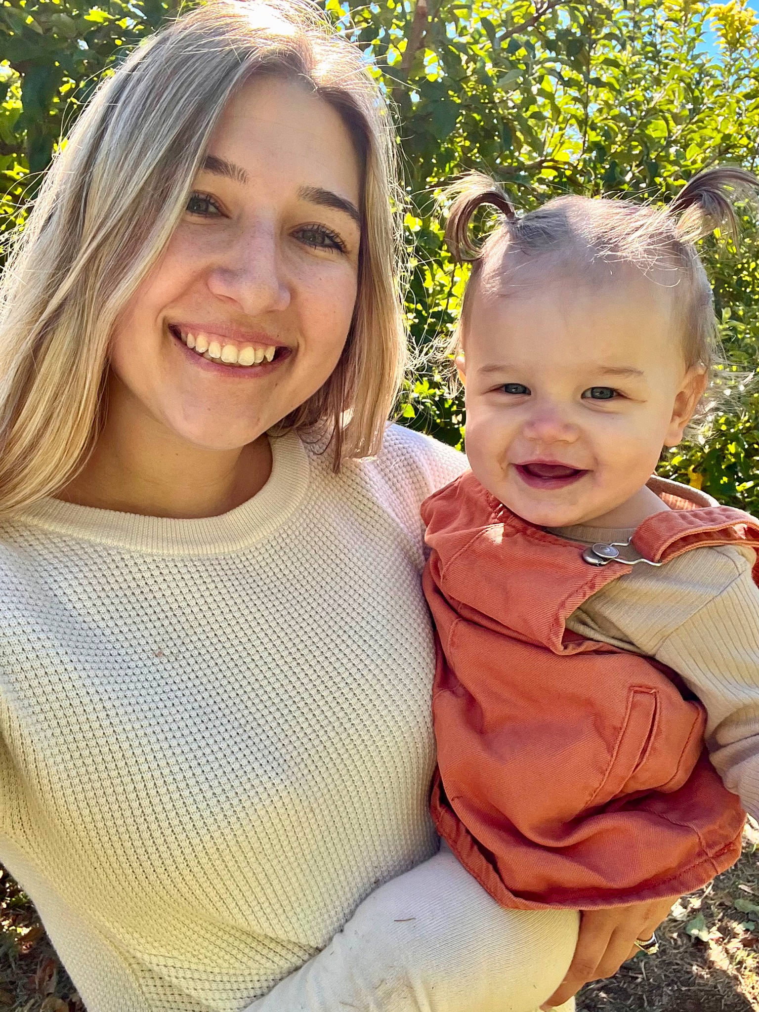 Allison is registered to the contest to win money with this photo: baby_toddler_clothing, botany, face, facial_expression, fun, gesture, grass, hairstyle, happy, interaction, iris, joy, leaf, lip, people_in_nature, person, plant, skin, smile, summer