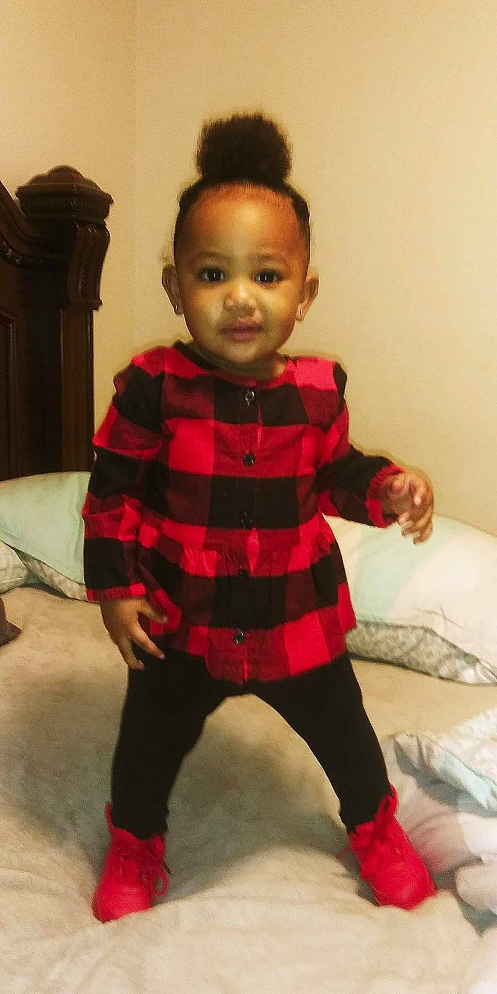Kortlyn is registered to the contest to win money with this photo: baby, baby_toddler_clothing, carmine, child, face, flooring, hairstyle, head, human_leg, knee, magenta, pattern, person, plaid, room, sitting, sleeve, sock, tartan, thigh