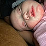 baby, sleeping, drool, pink_blanket, close_up, peaceful, infant, face, skin, child, resting, cute, soft_light, portrait, young, cozy, indoors, relaxed, newborn, tender