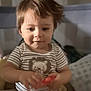 Matthew Gael joined the competition — help win amazing prizes! baby, casual_clothing, child, cozy, cute, cute_expression, focus, hands, home, indoor, lion_graphic, person, portrait, short_hair, sitting, smiling, striped_shirt, toddler, toy, young_child