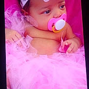 Aleyah is registered to the contest to win money with this photo: baby, infant, pacifier, pink, tutu, headband, flower, soft, cushion, portrait, child, cute, clothing, sleepy, resting, closeup, decorative, fabric, person, indoors
