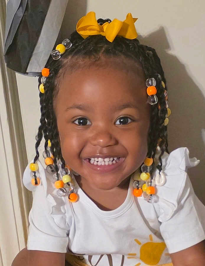 Jenesis joined the competition — help win amazing prizes! child, toddler, smiling, braids, beads, yellow_bow, white_shirt, sun_print, happy, portrait, indoor, cute, young_child, person, face, hair_accessory, bright_eyes, cheerful, closeup, fashion