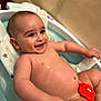 baby, bath, bathtub, toy, smiling, child, water, skin, happy, infant, seat, playful, red_toy, relaxing, cute, indoors, childhood, clean, naked, fun