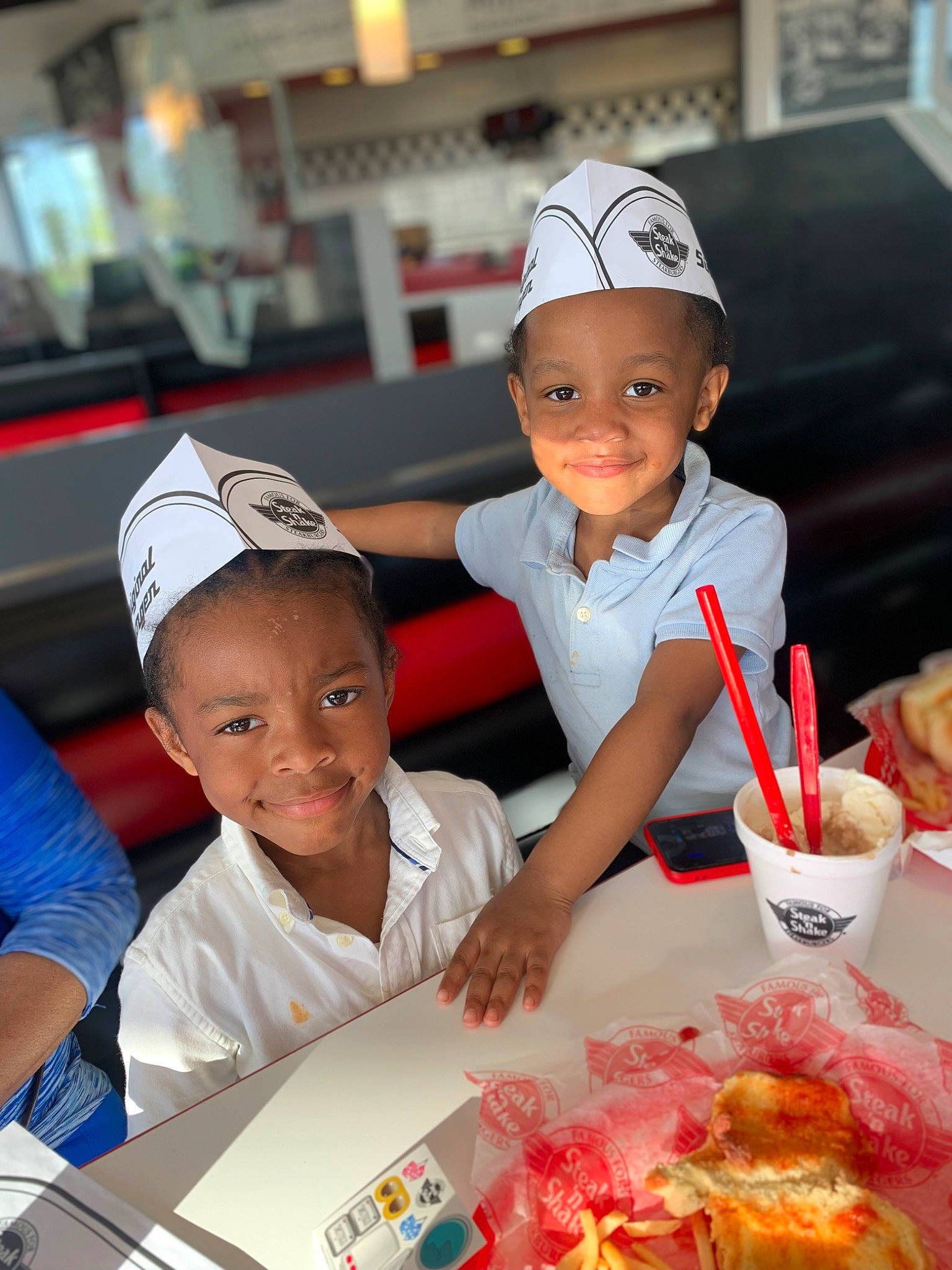 Darrin is registered to the contest to win money with this photo: baseball_cap, cap, child, comfort_food, cuisine, delicacy, dish, event, fast_food, food, fun, happy, hat, joy, junk_food, person, red, sharing, smile, t_shirt