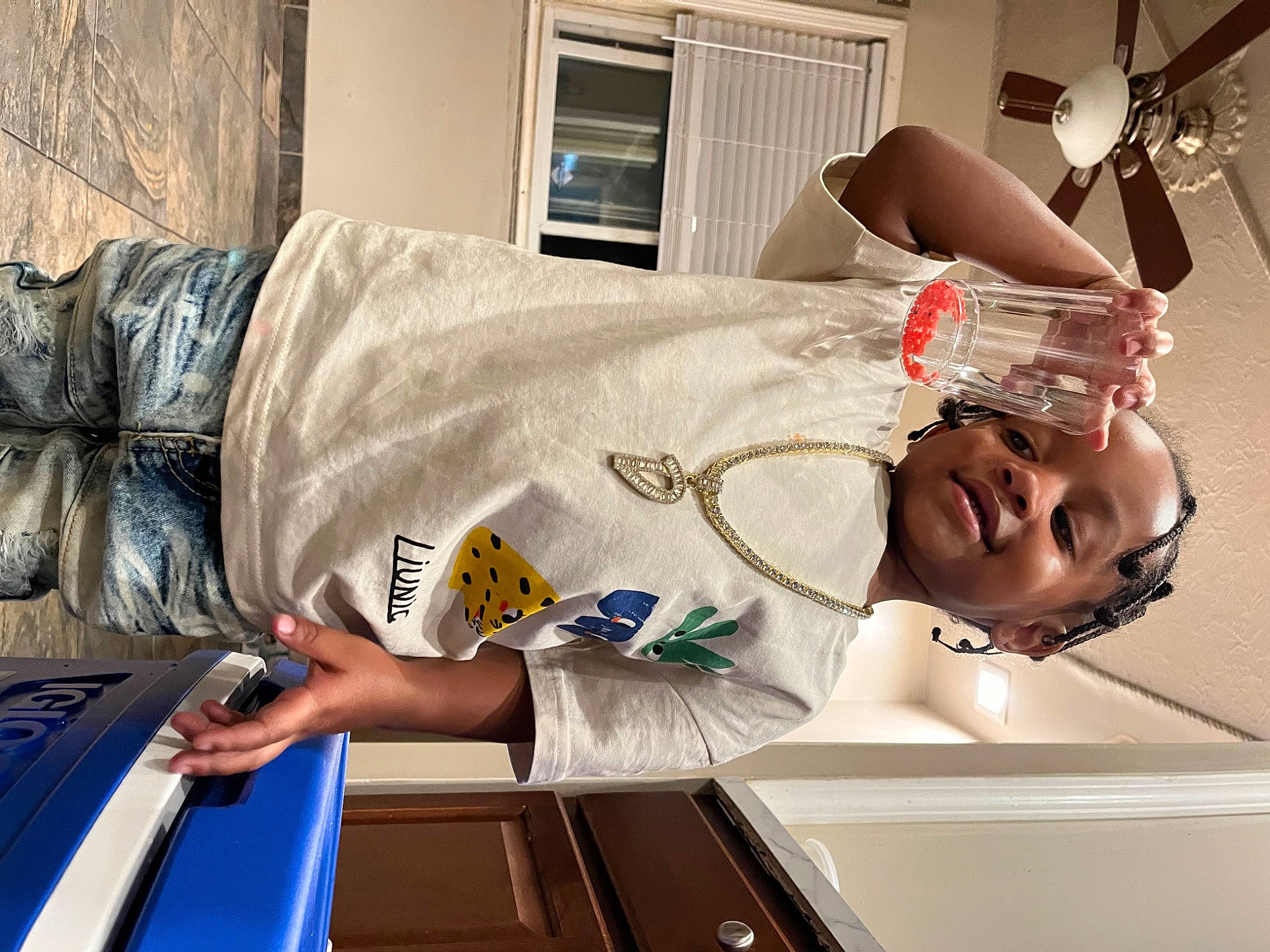 Dakari is registered to the contest to win money with this photo: arm, chest, comfort, couch, elbow, eyewear, flesh, flooring, fun, human_leg, joint, knee, linens, muscle, person, room, shoulder, sitting, t_shirt, thigh
