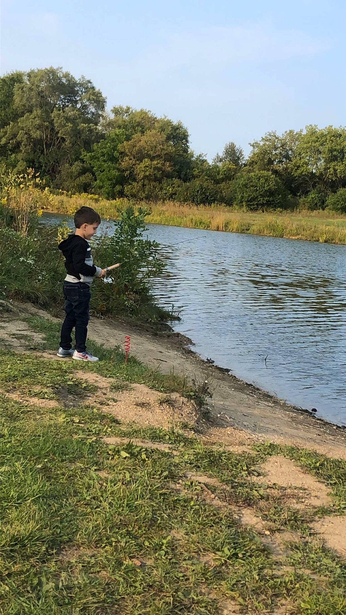 Kacper is registered to the contest to win money with this photo: bank, canal, child, grassland, lake, landscape, leisure, natural_environment, natural_landscape, park, person, pond, recreation, reservoir, river, tree, water, water_resources, watercourse, waterway