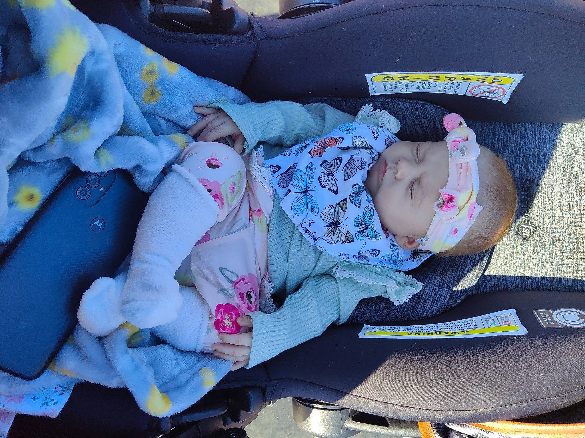 Ava is registered to the contest to win money with this photo: auto_part, baby, baby_carriage, baby_in_car_seat, baby_products, baby_toddler_clothing, car_seat, carmine, child, comfort, electric_blue, headwear, lap, nap, pattern, person, sitting, thigh, toddler