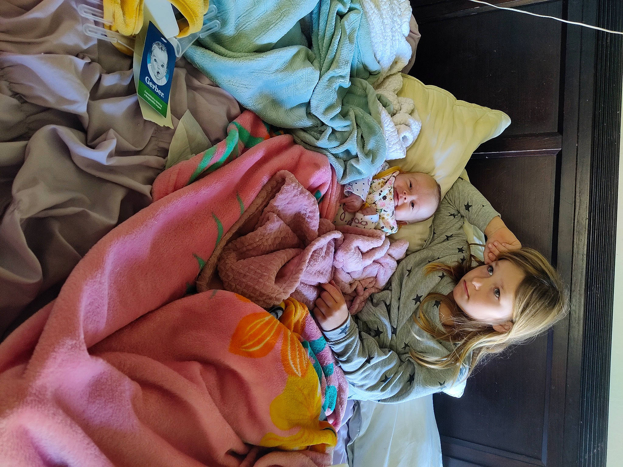 Isabella is registered to the contest to win money with this photo: baby, child, comfort, fashion_design, happy, linens, pattern, peach, person, room, textile, tree, wood