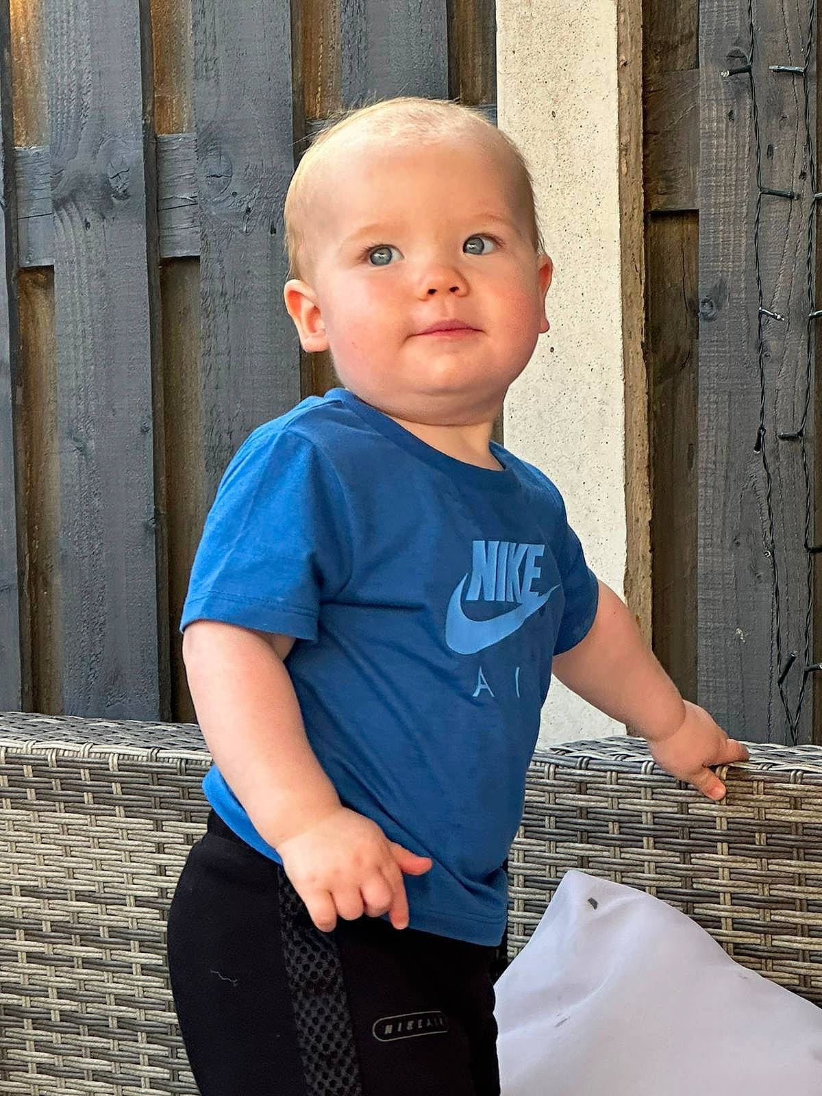 Freddie is registered to the contest to win money with this photo: baby, baby_toddler_clothing, child, denim, electric_blue, fun, happy, human_leg, pattern, person, shoulder, sitting, sleeve, t_shirt, toddler, waist, wood