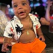 Kaizen is registered to the contest to win money with this photo: baby, child, toddler, shirt, shorts, necklace, portrait, smiling, happy, indoor, colorful, people, blurred_background, cute, young, skin, face, person, expression, clothing