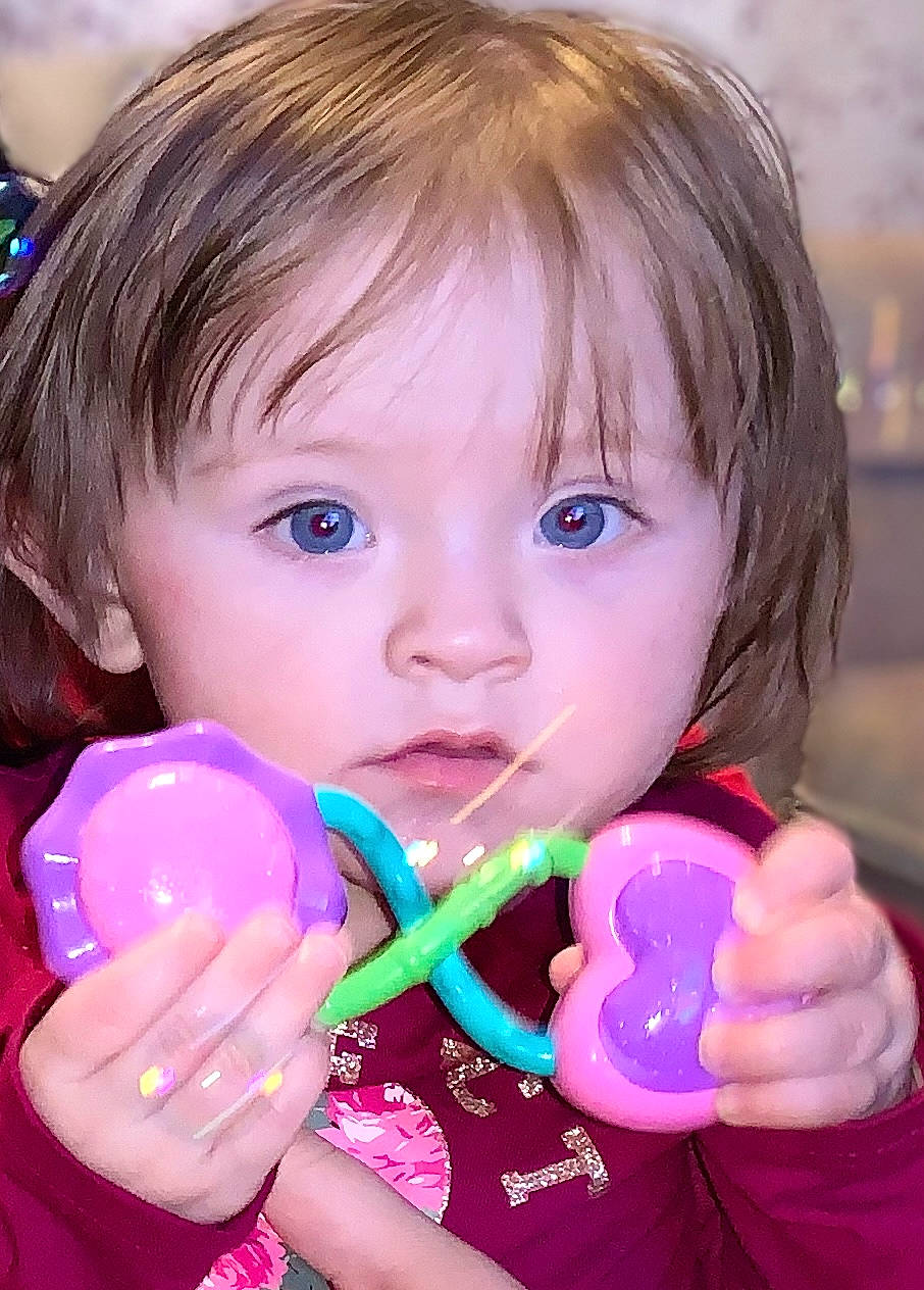 Alaia is registered to the contest to win money with this photo: baby_playing_with_toys, baby_toddler_clothing, beauty, blue, cheek, child, facial_expression, finger, fun, hand, happy, magenta, nose, organ, party_supply, people, person, pink, skin, toddler