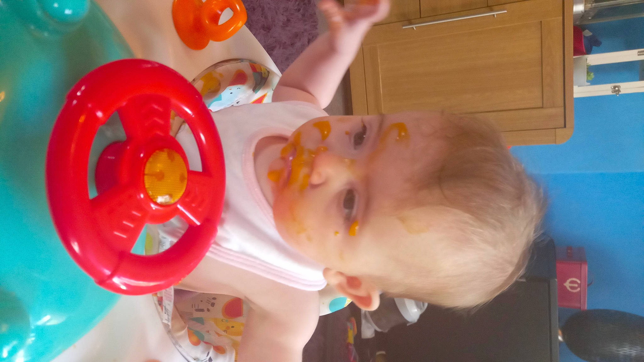 Ellie Mae is registered to the contest to win money with this photo: baby, baby_playing_with_toys, baby_products, baby_toddler_clothing, baby_toys, balloon, cabinetry, child, drinkware, fun, orange, party, party_supply, person, plastic, play, room, smile, toddler, toy