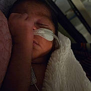 Delilah is registered to the contest to win money with this photo: newborn, baby, infant, sleeping, blanket, hospital, medical, nasal_cannula, oxygen, hand, closeup, face, resting, indoors, cozy, soft, healthcare, fragile, child, portrait