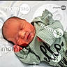 Kaylani is registered to the contest to win money with this photo: baby, child, cozy, cute, face, green_clothing, hand, indoors, infant, lying_down, mom_365, newborn, peaceful, person, portrait, resting, ribbed_fabric, sleeping, soft_bedding, watermark