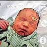 baby, closed_eyes, closeup, cute, face, green_clothing, hand, head, indoors, infant, lying_down, newborn, peaceful, portrait, resting, skin, sleeping, soft_fabric, text_overlay, watermark