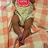 baby, blanket, checkered, child, cozy, cute, human, infant, lying_down, newborn, onesie, pacifier, patterned_clothing, peaceful, pink, resting, sleeping, small, soft, white