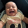 Zayvian is registered to the contest to win money with this photo: baby, laughing, mickey_mouse, shirt, child, smiling, seat, cushion, infant, happy, portrait, clothing, indoors, cute, person, head, face, young, joy, expression