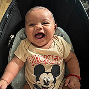 Zayvian joined the competition — help win amazing prizes! baby, smiling, laughing, mickey_mouse, onesie, infant, child, cushion, baby_seat, happy, cute, chubby_cheeks, black_cushion, light_skin, short_hair, red_bracelet, wood_floor, indoor, portrait, closeup