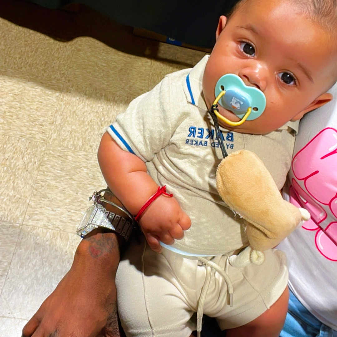 Zayvian joined the competition — help win amazing prizes! accessory, baby, bag, bracelet, clothing, cute, floor, footwear, hand, indoor, jeans, lap, pacifier, person, plush_toy, ring, sitting, skin, tattoo, watch