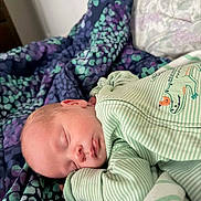Rylen joined the competition — help win amazing prizes! baby, sleeping, onesie, green_clothing, crocodile_design, blanket, patterned_blanket, purple, teal, bedroom, infant, peaceful, resting, face, head, hand, soft_lighting, close_up, portrait, cozy