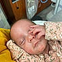 Mercedes is registered to the contest to win money with this photo: baby, newborn, sleeping, portrait, hand, onesie, floral_pattern, face, eyelid, nursery, hospital, blanket, skin, close_up, infant, cheek, nose, mouth, resting, soft_tissue